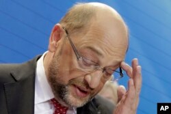 Party chairman and top candidate Martin Schulz addresses his supporters in the headquarters of the Social Democratic party in Berlin, Germany, Sept. 24, 2017, after the polling stations for the German parliament elections had been closed. The sign reads :