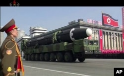 FILE - A military parade is held in Pyongyang, North Korea, Feb. 8, 2018. North Korea's intercontinental ballistic missiles highlighted the event.