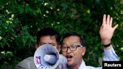 Sam Rainsy, president of the National Rescue Party, addresses his supporters at the CNRP office in Phnom Penh, August 16, 2013.