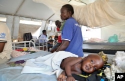 Two-year-old South Sudanese refugee Simon is accompanied by his grandmother as he is treated for malnutrition in Bidi Bidi camp, northern Uganda, March 15, 2017.