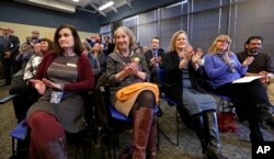 Center for Gun Responsibility board members applaud at a news conference in Burien, Wash., where Gov. Jay Inslee announced a statewide public health initiative to reduce and prevent firearm-related injuries and deaths, Jan. 6, 2016.