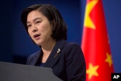 FILE - Chinese Foreign Ministry spokeswoman Hua Chunying speaks during a briefing at the Chinese Foreign Ministry in Beijing.