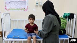 Two-year-old Ismail Abu Naji receives treatment for sores on his legs at Kamal Adwan Hospital in Beit Lahia, in the northern Gaza Strip, on July 29, 2024. U.N. agencies say scabies, chicken pox, skin rashes and lice are spreading quickly in Gaza. 