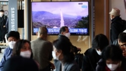 FILE - People watch a TV broadcasting file footage of a news report on North Korea firing a ballistic missile off its east coast, in Seoul, South Korea, Oct. 19, 2021.