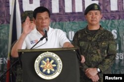 Philippines' President Rodrigo Duterte gestures as he talks to the troopers during his visit to Camp Teodulfo Bautista in Jolo, Sulu, Philippines, May 27, 2017.