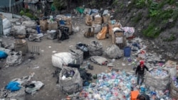Afghan refugees collect waste at a makeshift dumping ground on Nov. 18, 2021, in Istanbul.