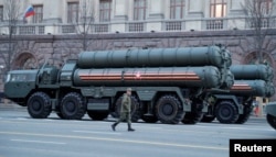 A Russian serviceman walks past S-400 missile defense systems in central Moscow, Russia, April 29, 2019.