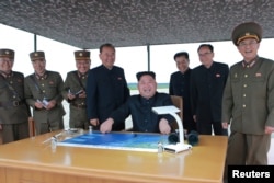 North Korean leader Kim Jong Un inspects a long and medium-range ballistic rocket launch drill in this undated photo released by North Korea's Korean Central News Agency in Pyongyang, Aug. 30, 2017.