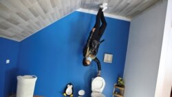 A woman poses for a photo inside the upside down house, in Guatavita, Colombia, January 23, 2022. Picture taken January 23, 2022. REUTERS/Luisa Gonzalez