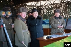 FILE - Undated photo released by North Korea's official Korean Central News Agency (KCNA) on Feb. 21, 2016 shows North Korean leader Kim Jong-Un (C) inspecting maneuvers for attack and defense between large combined units of the Korean People's Army (KPA).