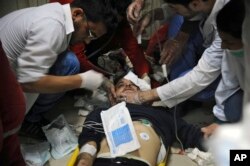 This photo released by the Syrian official news agency SANA shows a man receiving treatment at a hospital in Damascus, Syria, April. 7, 2018. State TV said Army of Islam fighters pelted several neighborhoods in Damascus with mortar shells, killing six civilians.