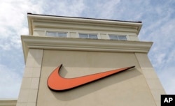 FILE - A Nike logo is displayed outside a Nike store in Charlotte, N.C., Sept. 4, 2018.