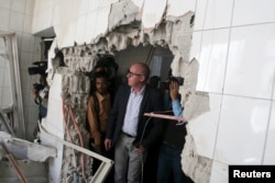 Resident Coordinator of the United Nations in Yemen, Jamie McGoldrick, inspects damage at a hospital in Yemen's southwestern city of Taiz, Jan. 21, 2016.
