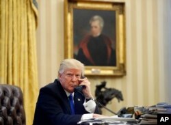 FILE - In this Jan. 28, 2017, file photo, President Donald Trump speaks on the telephone with Australian Prime Minister Malcolm Turnbull in the Oval Office of the White House in Washington.