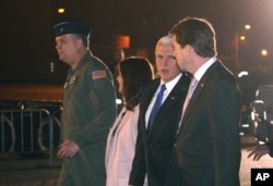 U.S. Vice President Mike Pence, second right, and his wife Karen are escorted to a waiting helicopter by the U.S. Ambassador to Japan William Hagerty, right in Fussa, Japan, Nov. 12, 2018.