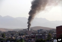 FILE - Smoke billows from a fire during firefight between the police and Kurdistan Workers' Party, or PKK militants in the town of Silopi, southeastern Turkey, July 7, 2015.