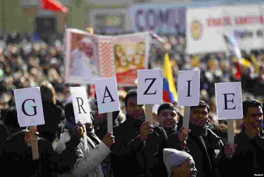A sign reading "Thank you" in Italian is held in St. Peter's Square as Pope Benedict holds his last general audience at the Vatican, Feb. 27, 2013.