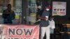 A customer walks past a now hiring sign at an eatery in Richardson, Texas, Sept. 2, 2020. 