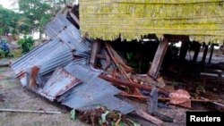 A damaged house is seen after a tsunami hit the Venga village on Solomon Islands, February 7, 2013. 