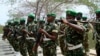 FILE — Burundian soldiers, part of the African Union troops, march at their base in Mogadishu, Somalia, Jan. 24, 2011. The Africa Union Peace and Security Council has approved Somalia's request for a three-month pause of the withdrawal of 3,000 peacekeepers.