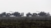 FILE - Ukrainian tanks are transported towards Ukraine's eastern Luhansk region, Dec. 12, 2021.