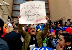 Opposition leader Juan Guaido supporters celebrate during the eviction and arrest of Nicolas Maduro's supporters from the Venezuelan Embassy in Washington, May 16, 2019.