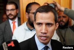 Venezuelan opposition leader and self-proclaimed interim president Juan Guaido talks to the media before a session of the Venezuela’s National Assembly in Caracas, Jan. 29, 2019.