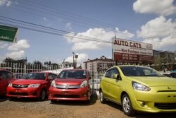 In this photo taken Feb. 13, 2020, used cars for sale are parked in a yard in Nairobi, Kenya.