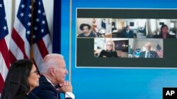 President Joe Biden and Interior Secretary Deb Haaland listen during an event in the White House complex in Washington, June 30, 2021, with cabinet officials and governors from Western states to discuss drought and wildfires.