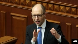 Ukrainian Prime Minister Arseniy Yatsenyuk, speaks to lawmakers during a session at the Ukrainian parliament in Kyiv.