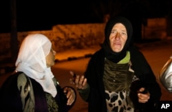 Residents talk to reporters in the besieged town of Madaya, northwest of Damascus, Syria on Jan. 11, 2016.