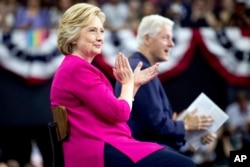 FILE - Democratic presidential candidate Hillary Clinton and former President Bill Clinton arrive for a rally at McGonigle Hall at Temple University in Philadelphia, July 29, 2016.