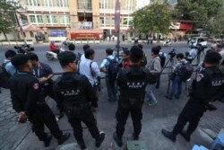 FILE - Cambodian military police officers stand guard in front of the Phnom Penh Municipal Court before a hearing of Kem Sokha, the head of the dissolved Cambodia National Rescue Party, in Phnom Penh, Jan. 14, 2020.