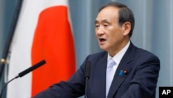 Japan's Chief Cabinet Secretary Yoshihide Suga speaks during a press conference to announce the new line up of Cabinet at the prime minister's official residence in Tokyo, Thursday, Aug. 3, 2017.
