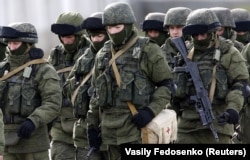 Russian servicemen walk in formation near a Ukrainian military base in the village of Perevalnoye outside Simferopol, Crimea, March 6, 2014.