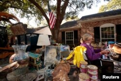 Ginger Benfield works to save family photos in the aftermath of tropical storm Harvey in west Houston, Texas, U.S. September 11, 2017.