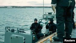 FILE - Navy divers of the Latvian Armed Forces take part in NATO exercise Freezing Winds 24, led by the Finnish Navy, in the Gulf of Finland, the Baltic Sea, Finland, Nov. 23, 2024. 