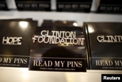 FILE - A Clinton Foundation brooch is seen for sale at the Clinton Museum Store in Little Rock, Arkansas, April 27, 2015.