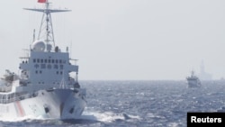 Chinese Coast Guard ships are seen near Chinese oil rig Haiyang Shi You 981 in the South China Sea, about 210 km (130 miles) off Vietnamese coast, May 14, 2014. 