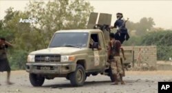 FILE - This still image taken from video provided by Arab 24 shows Saudi-led forces fighting to retake the international airport of Yemen's rebel-held port city of Hodeida from Shiite Houthi rebels, June 16, 2018.