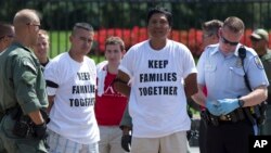 Demonstrators are arrested outside the White House in Washington, Aug. 28, 2014, during a protest for immigration reform. Trump's plans could lead to the deportation of more than six million illegal immigrants.