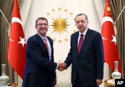 Turkey's President Recep Tayyip Erdogan, right, and U.S Secretary of Defense Ash Carter shake hands before a meeting in Ankara, Turkey, Oct. 21, 2016.
