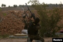 Syrian Democratic Forces (SDF) fighters shoot a drone they said belonged to Islamic State fighters on the bank of the Euphrates river, west of Raqqa city, Syria, April 8, 2017.