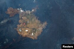 Lava threatens homes on the outskirts of Pahoa during ongoing eruptions of the Kilauea Volcano in Hawaii, June 5, 2018.