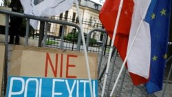 FILE - A banner reading 'No Polexit' is pictured outside the Constitutional Tribunal building during a demonstration in Warsaw, Poland, on Sept. 22, 2021.
