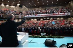Turkish President Recep Tayyip Erdogan salutes people gathered to celebrate the Muslim holiday of Eid al-Adha in Istanbul, Sept. 13, 2016. Erdogan said Monday the country will send food, clothing and children's toys to Aleppo, Syria after a U.S.-Russia brokered ceasefire takes effect.