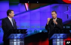 Republican presidential candidate, Ohio Gov. John Kasich, right, speaks as Republican presidential candidate, Sen. Ted Cruz, R-Texas, listens, during the Republican presidential debate, March 10, 2016.