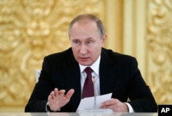 FILE - Russian President Vladimir Putin delivers a speech during a session of the Council for Civil Society and Human Rights in Moscow, Dec. 8, 2016.