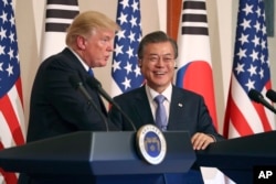 FILE - President Donald Trump, left, speaks as South Korean President Moon Jae-in looks on during a joint news conference at the Blue House in Seoul, South Korea, Tuesday, Nov. 7, 2017.