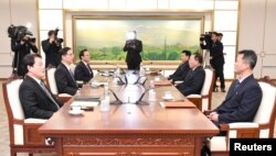 Head of the North Korean delegation Jon Jong Su talks with his South Korean counterpart Chun Hae-sung during their meeting at the truce village of Panmunjom in the demilitarized zone separating the two Koreas, South Korea, Jan. 17, 2018.